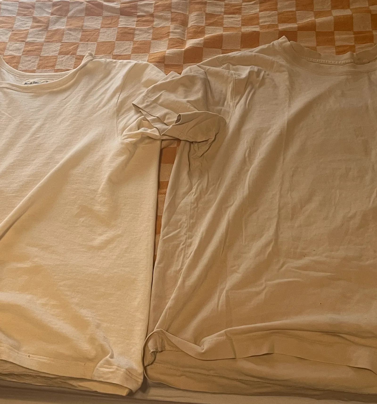 2 t shirts on a blanket